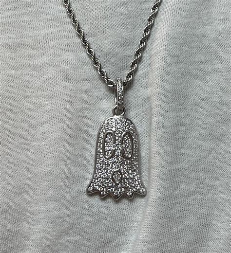 guccighost charm necklace.